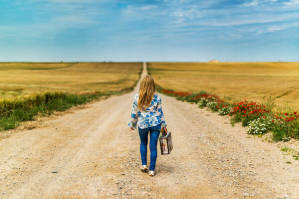 girl carrying small suitcase