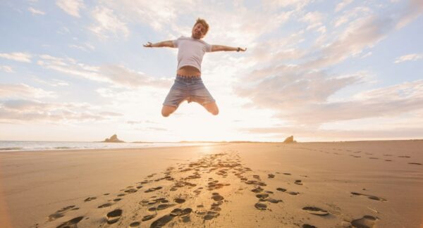 Man jumping for joy on beach