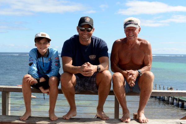 travel insurance for multi-generational holidays - Father, son and grandfather at the beach