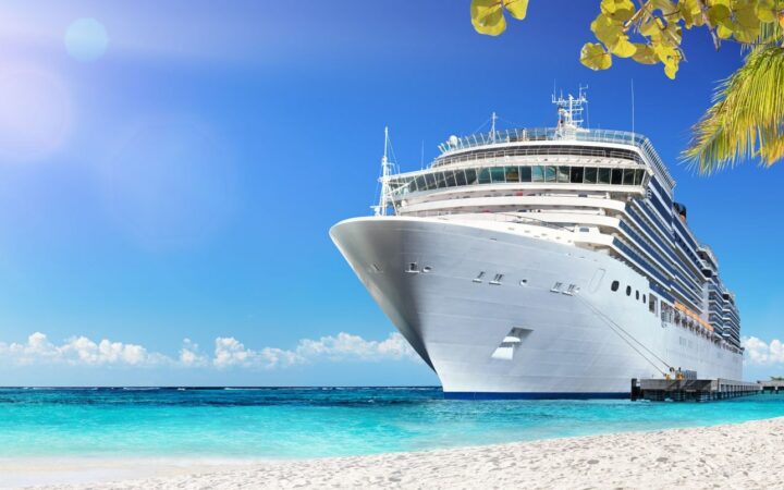 Cruise insurance - cruise ship by beautiful beach